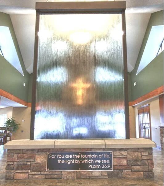 entry fountain with blurred glass and lighted cross